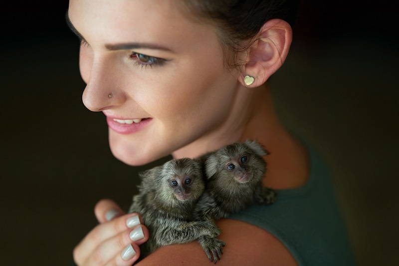 kobieta małpkami na ramieniu